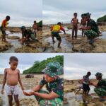 Personel Satgas TMMD Bermain dan Mencari Ikan Bersama Anak-anak Saat Air Laut Surut